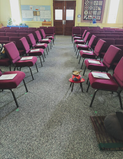 A meditation room with chairs lined up in order.