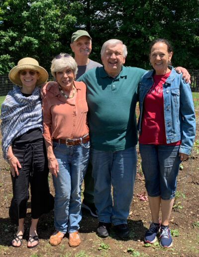 Group of people standing in a field.
